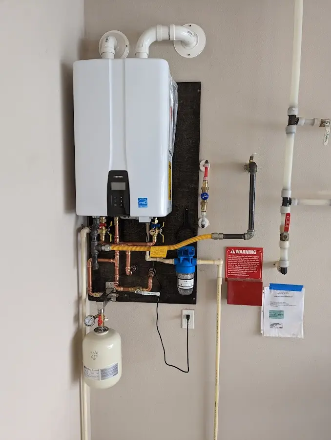 Professional plumber installing copper piping in a Five Forks home